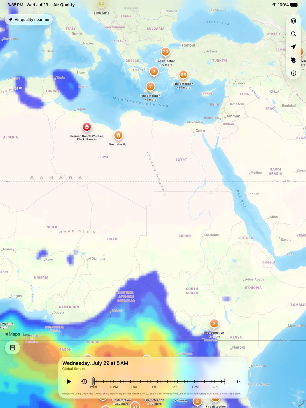 Air Quality Index on iPad showing the global smoke forecast across the Mediterranean, Sahara, and Central Africa, with satellite fire detection clusters and the forecast timeline docked at the bottom.